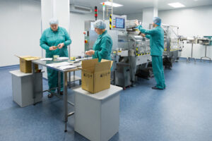 Medical device assembly and packaging by technicians in cleanroom using automated machinery